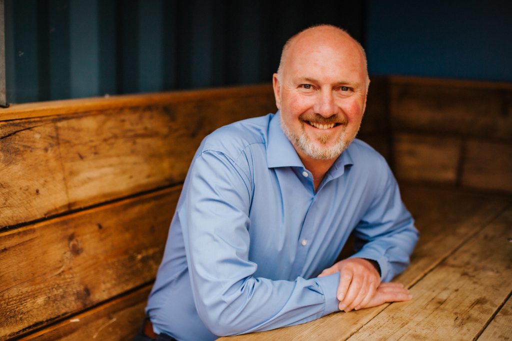 A headshot of Peter Wells, Chief Executive Officer of Wells & Co
